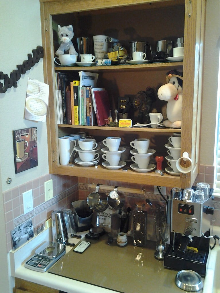 A home espresso bar setup with a Gaggia machine, grinder, and supporting tools