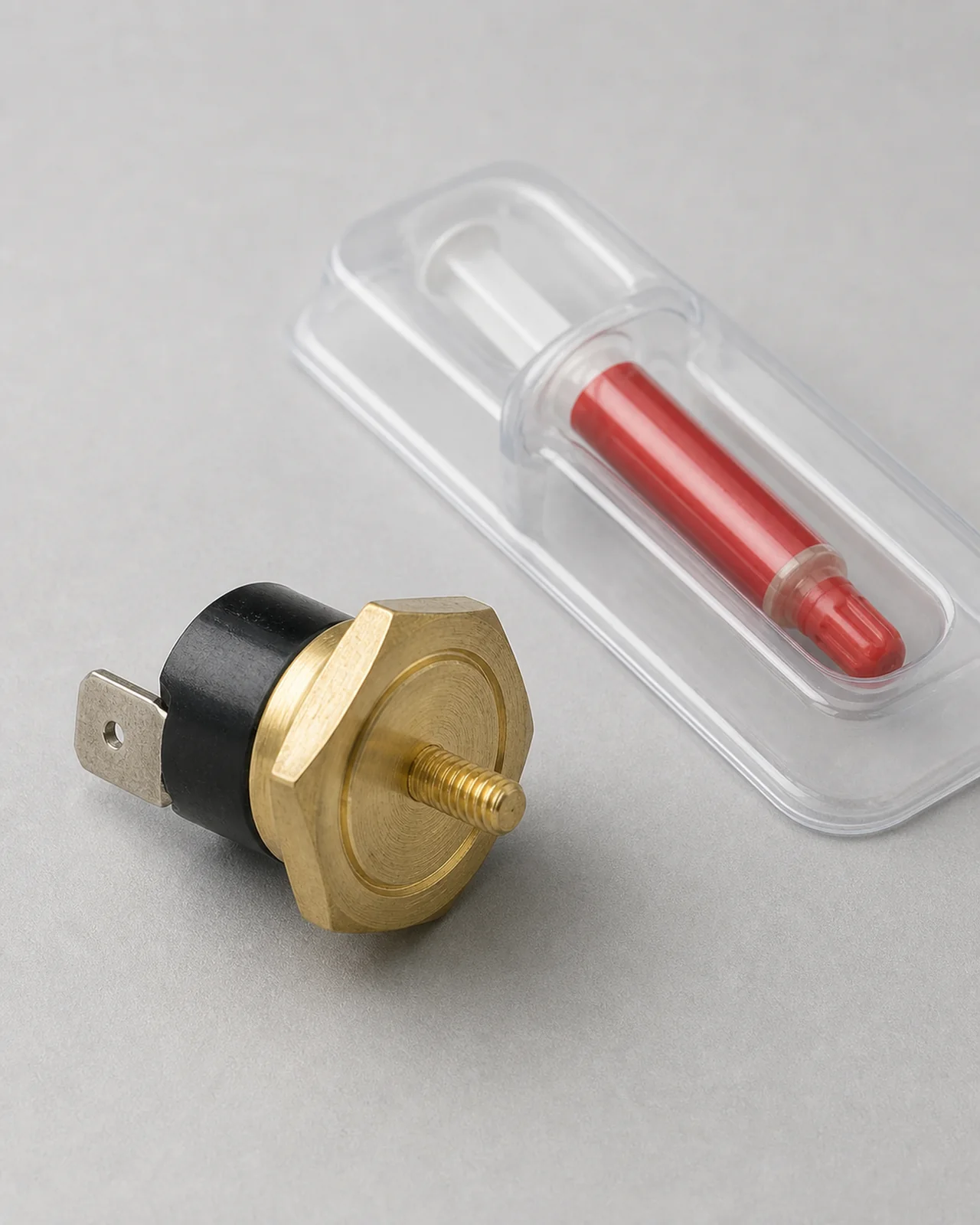 Brass thermostat mounting surface beside the included thermal grease