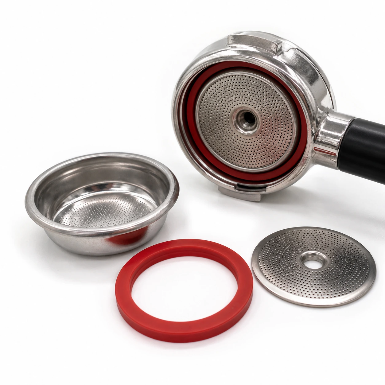 Gasket beside a portafilter, basket, and shower screen during maintenance