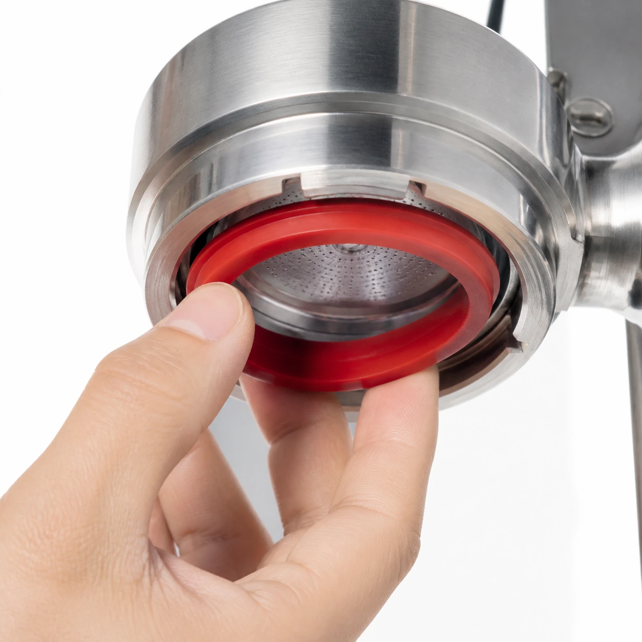 Hand fitting the red silicone gasket into an E61 brew head groove