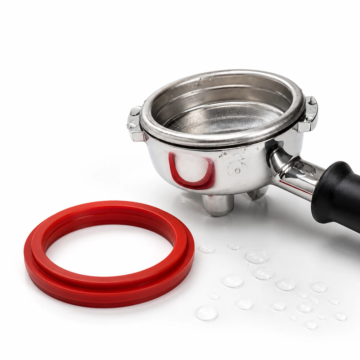 Portafilter with water droplets beside a replacement red silicone gasket