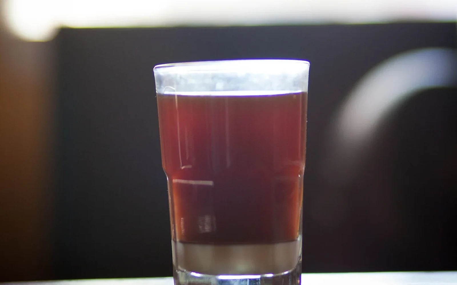 Glass of filtered cold brew coffee with a clear surface