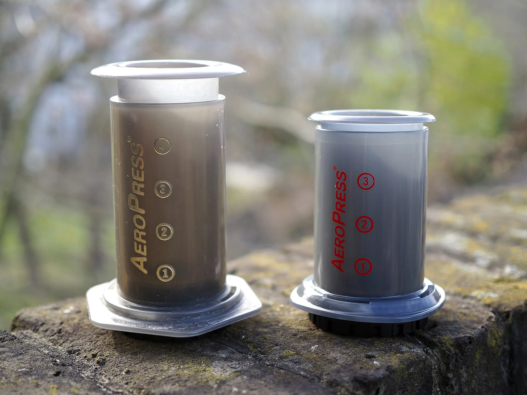 A 2015 AeroPress Original beside a smaller 2020 AeroPress Go