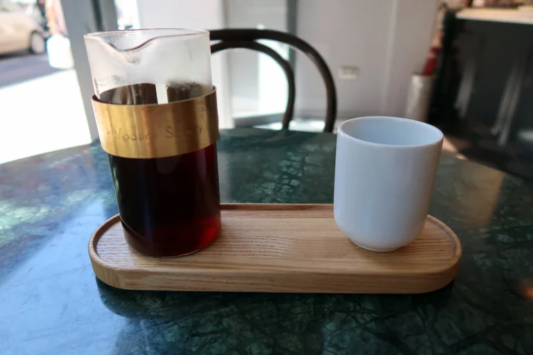 Chemex coffee carafe and a mug on a wooden serving tray