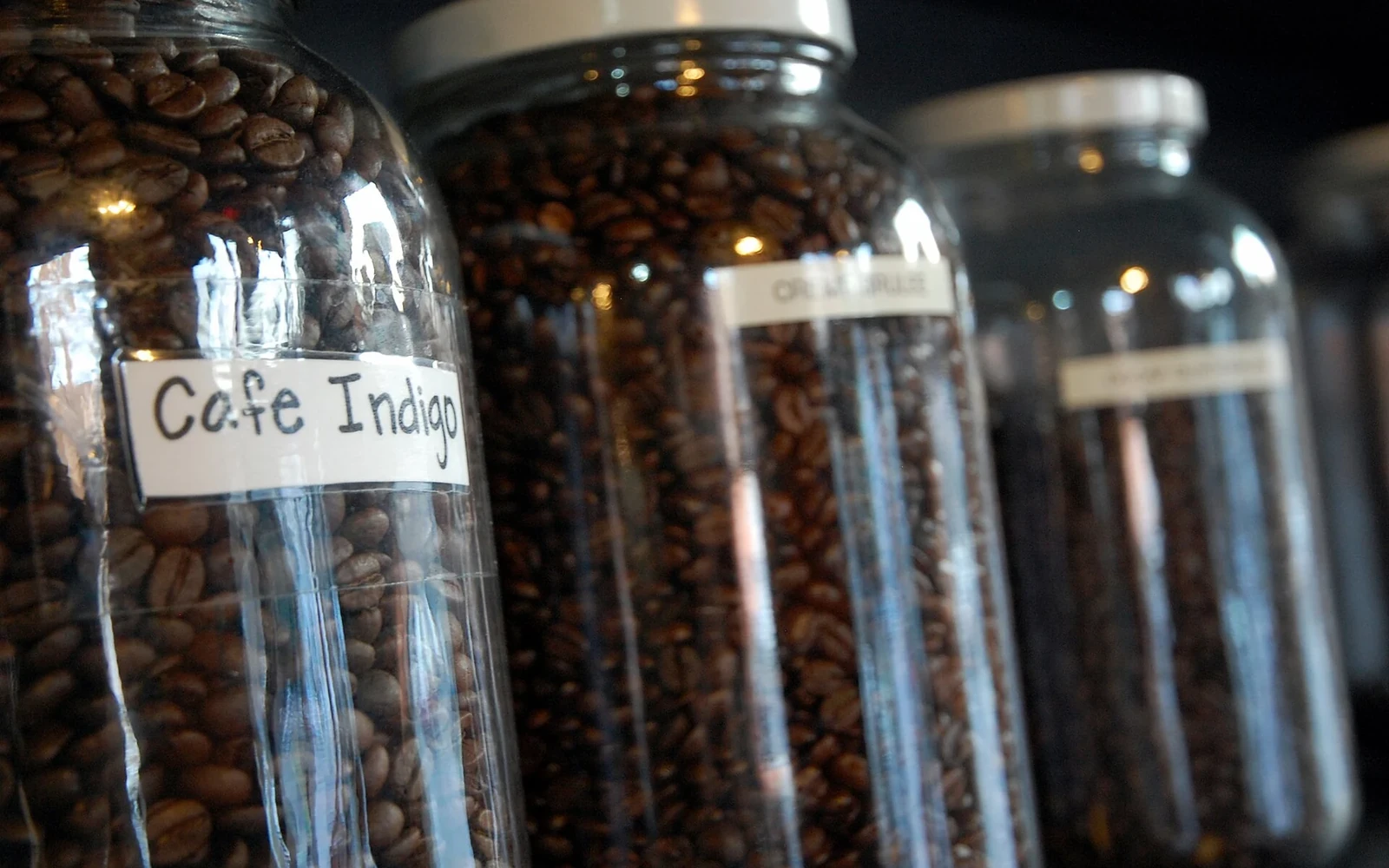 Roasted coffee beans in clear glass jars