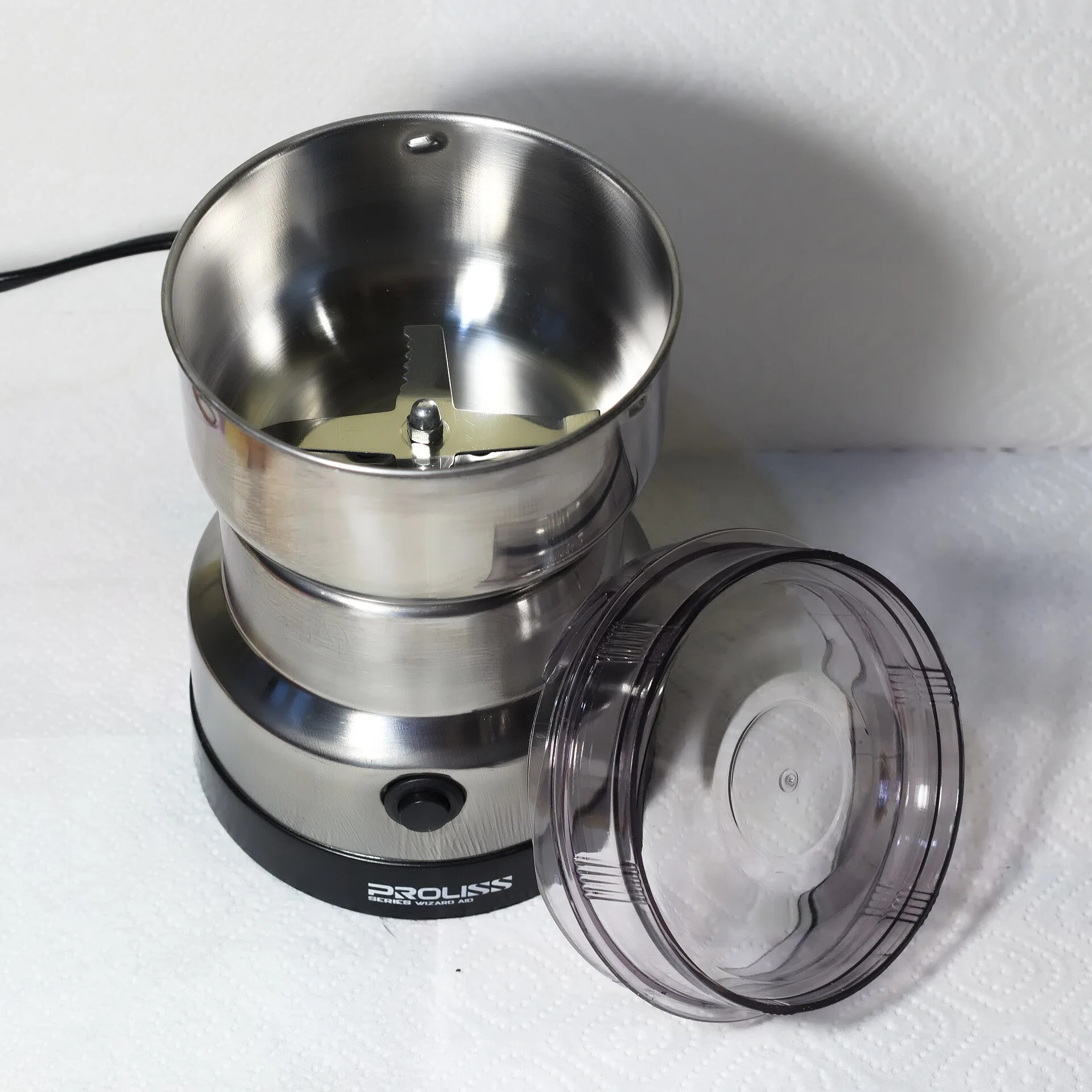 An open blade coffee grinder with its central blade visible