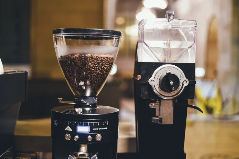 Two electric coffee grinders with bean hoppers